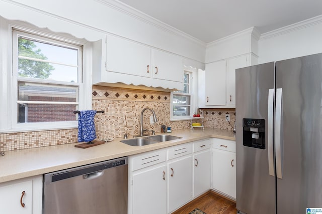 kitchen featuring white cabinets, decorative backsplash, sink, and appliances with stainless steel finishes