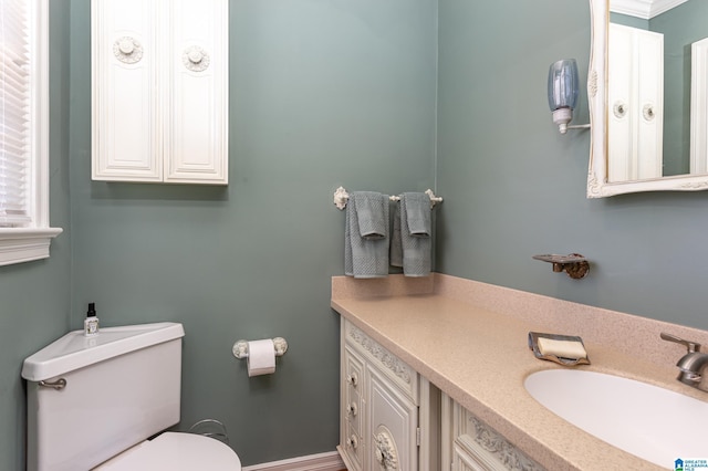 bathroom featuring crown molding, vanity, and toilet