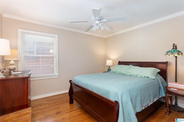 bedroom with ceiling fan, hardwood / wood-style floors, and crown molding