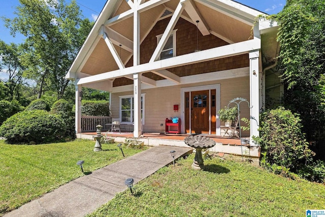 view of front of property featuring covered porch and a front lawn