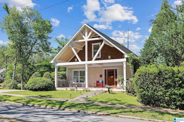 craftsman-style house featuring a porch and a front yard