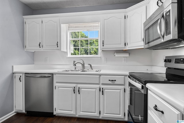 kitchen with white cabinetry, sink, and stainless steel appliances