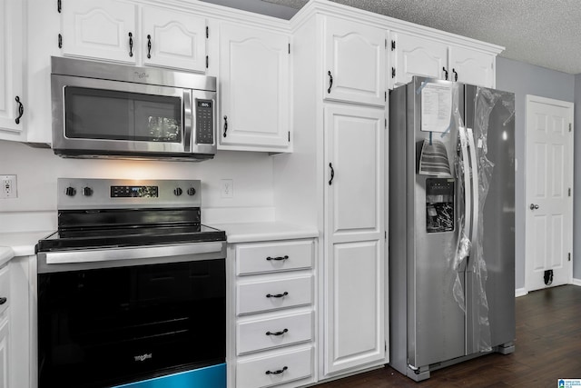 kitchen featuring a textured ceiling, dark hardwood / wood-style flooring, stainless steel appliances, and white cabinetry