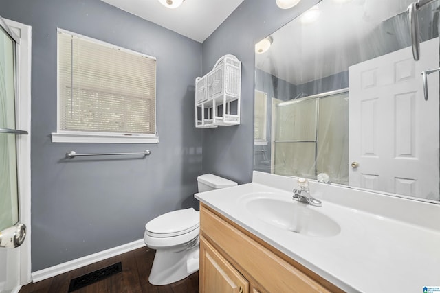 bathroom with vanity, hardwood / wood-style flooring, toilet, and walk in shower