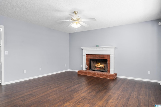 unfurnished living room with a fireplace, a textured ceiling, dark hardwood / wood-style floors, and ceiling fan