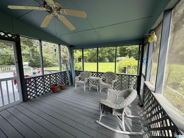 sunroom / solarium featuring lofted ceiling and ceiling fan