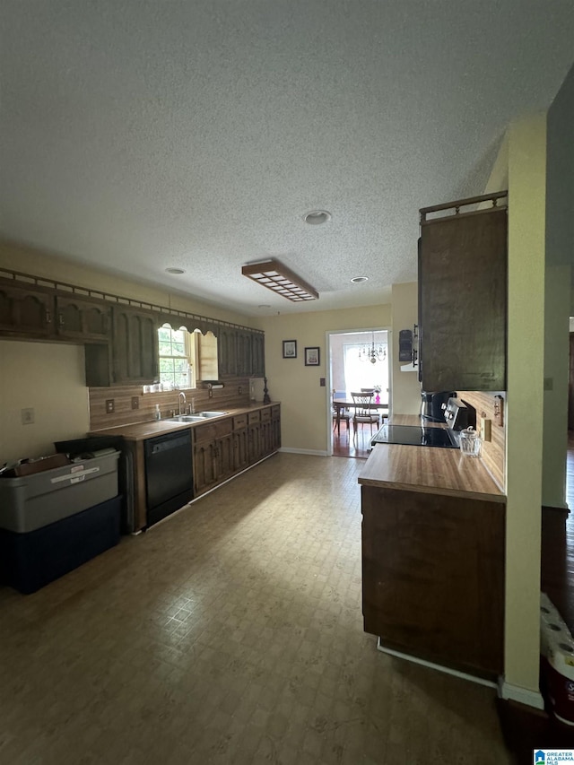 kitchen featuring sink, a textured ceiling, dishwasher, stove, and kitchen peninsula