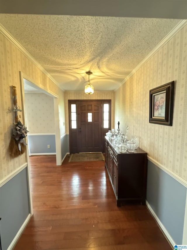 foyer featuring crown molding and dark hardwood / wood-style floors