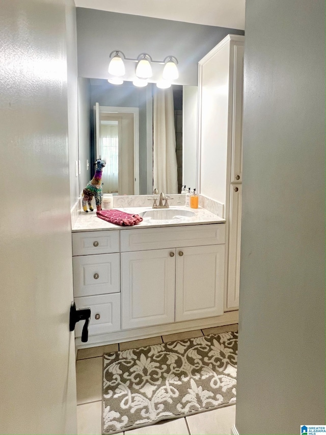 bathroom with tile patterned flooring and vanity