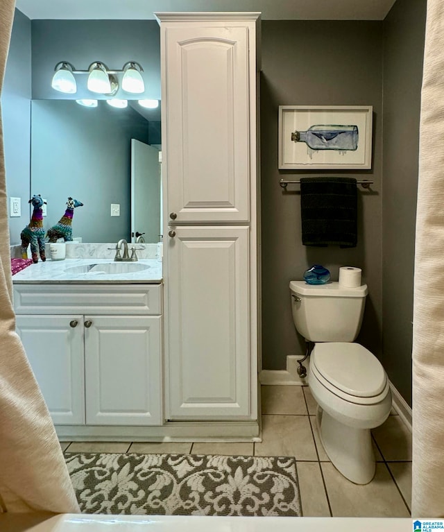 bathroom with tile patterned floors, vanity, and toilet