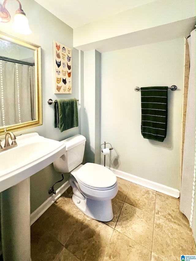 bathroom featuring toilet and sink