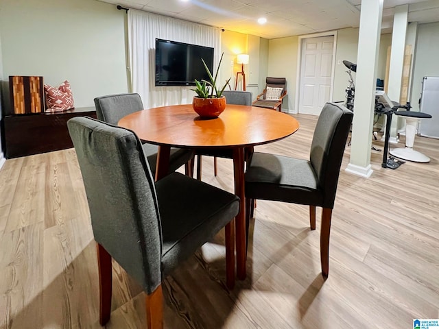 dining space with light hardwood / wood-style floors