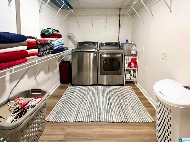 laundry room featuring wood-type flooring and independent washer and dryer