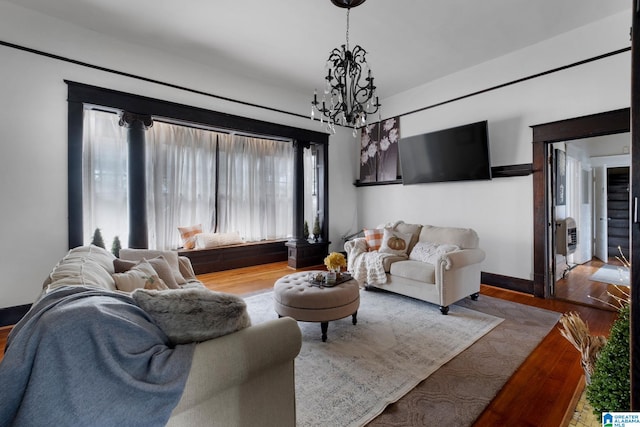 living room featuring an inviting chandelier and light hardwood / wood-style floors