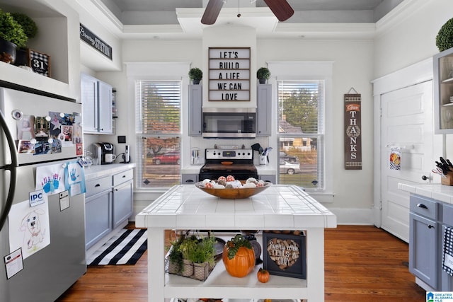 kitchen with gray cabinets, appliances with stainless steel finishes, and tile countertops