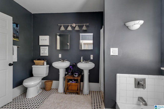 bathroom with tile patterned flooring, sink, and toilet