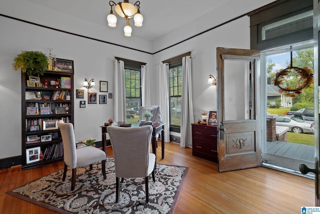 dining area with light hardwood / wood-style flooring and a chandelier