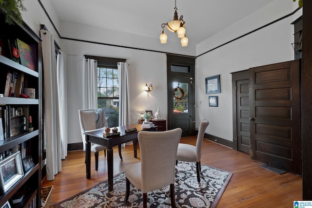 dining area featuring a notable chandelier and light hardwood / wood-style floors