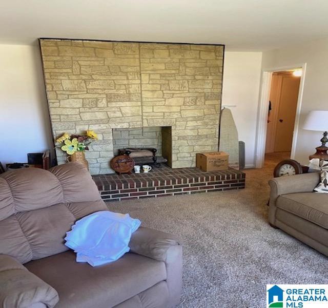 living room featuring carpet flooring and a fireplace