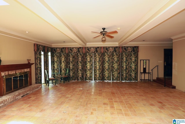 unfurnished living room featuring ceiling fan, beam ceiling, ornamental molding, and a brick fireplace