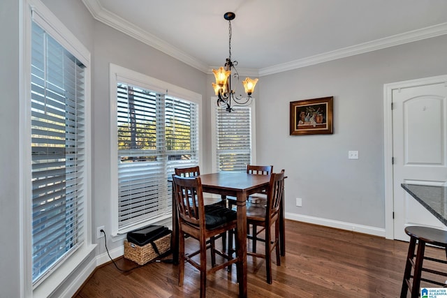 dining room featuring dark hardwood / wood-style flooring, ornamental molding, and an inviting chandelier