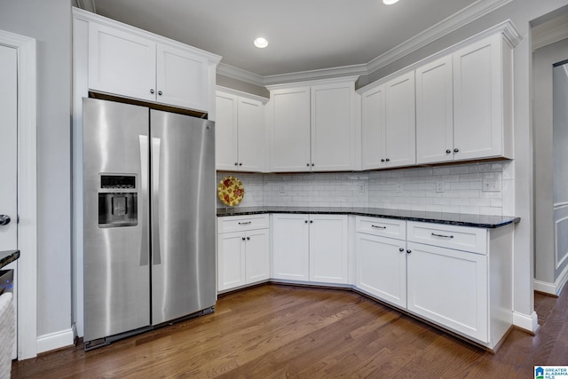 kitchen with stainless steel fridge and white cabinets