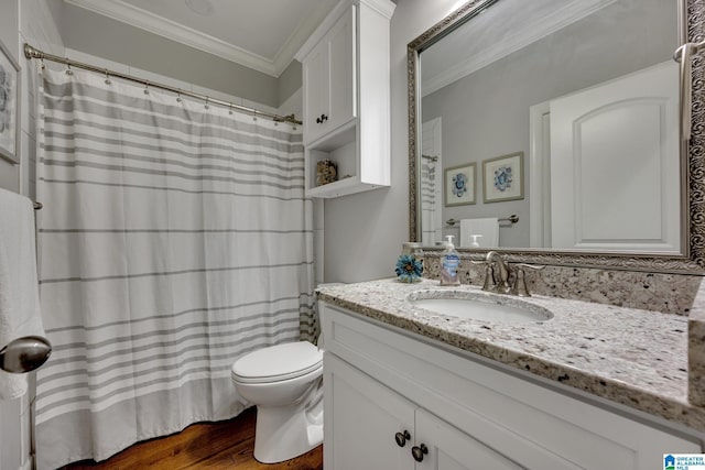 bathroom with crown molding, hardwood / wood-style floors, vanity, and toilet