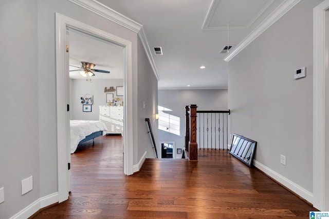 hall with dark hardwood / wood-style flooring and crown molding