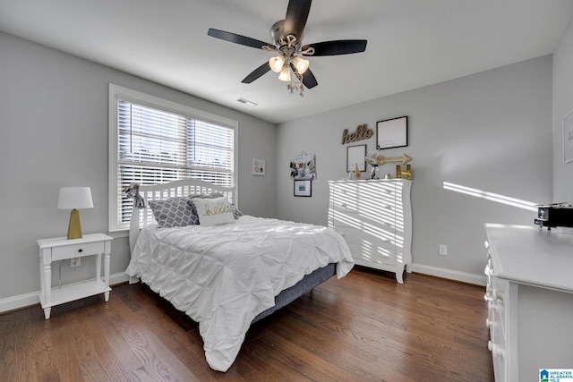 bedroom with dark hardwood / wood-style floors and ceiling fan