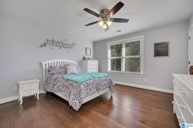 bedroom with dark hardwood / wood-style flooring and ceiling fan