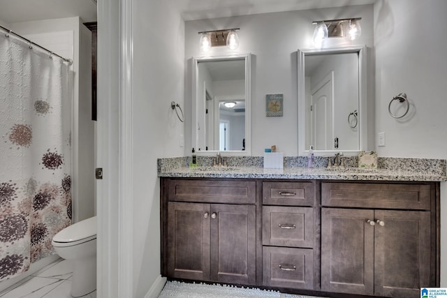 bathroom featuring vanity and toilet