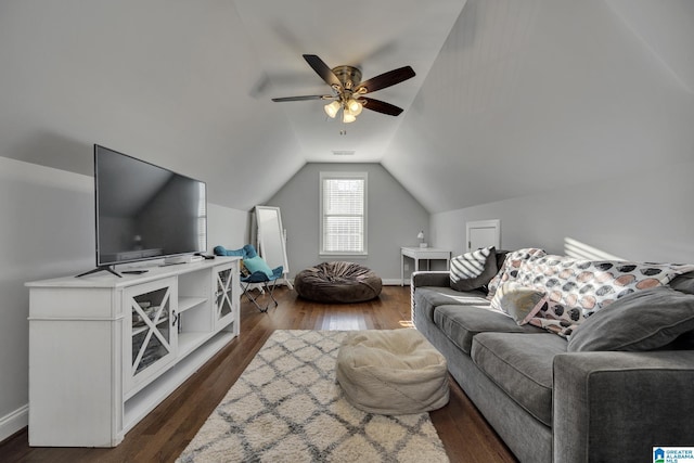 living room featuring dark hardwood / wood-style floors, ceiling fan, and vaulted ceiling