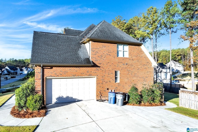 view of side of home featuring a garage