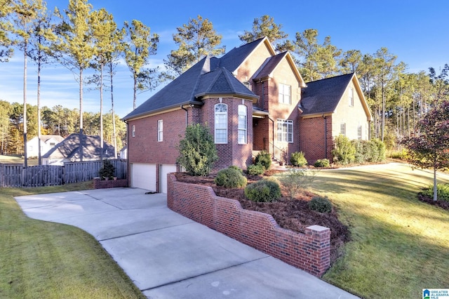 view of front of property with a front yard and a garage