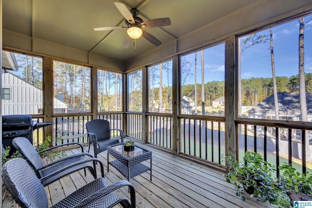 sunroom with a wealth of natural light and ceiling fan