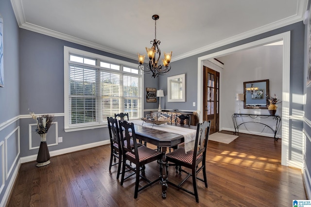 dining area featuring a notable chandelier, ornamental molding, and dark wood-type flooring