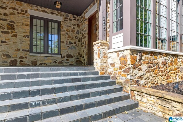 stairway with crown molding, a high ceiling, and a notable chandelier