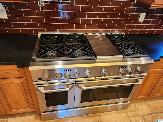 kitchen featuring tasteful backsplash and range with two ovens