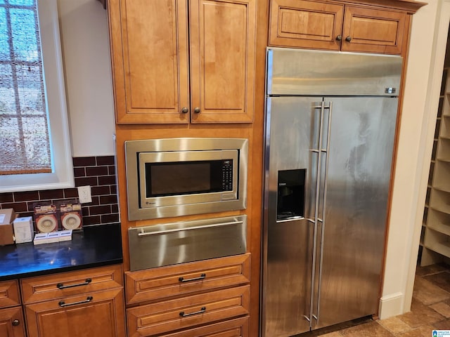 kitchen with tasteful backsplash and built in appliances