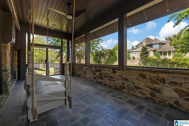 unfurnished sunroom with ceiling fan and wooden ceiling