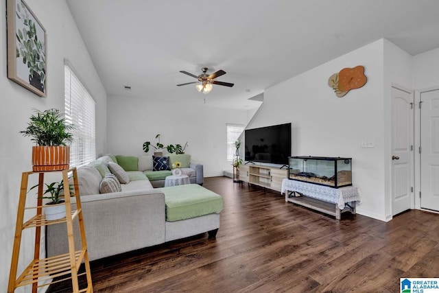 living room featuring ceiling fan and dark hardwood / wood-style flooring