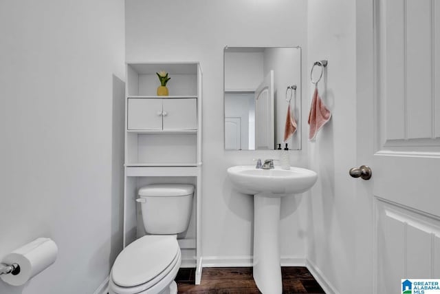 bathroom featuring hardwood / wood-style floors, toilet, and sink