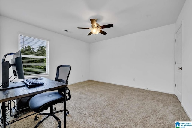 carpeted office featuring ceiling fan