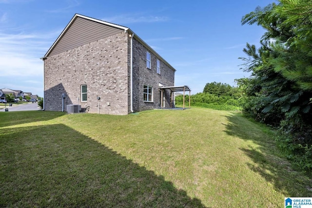 view of home's exterior with central AC unit and a yard