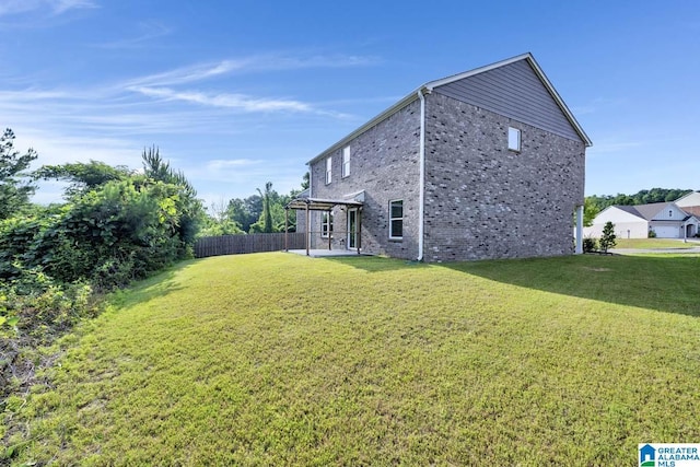 rear view of property with a patio area and a yard