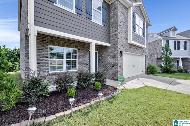 view of front of property featuring a front lawn and a garage