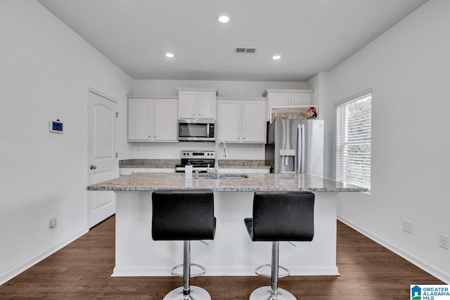 kitchen featuring white cabinetry, sink, an island with sink, and stainless steel appliances