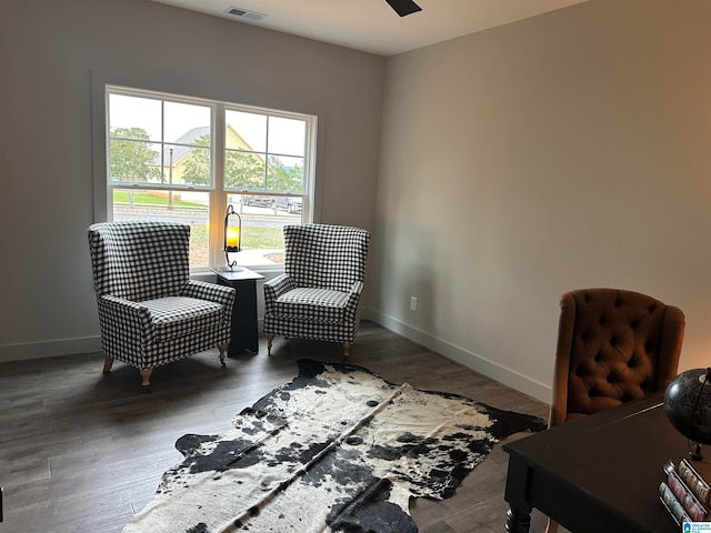 sitting room with hardwood / wood-style flooring and ceiling fan