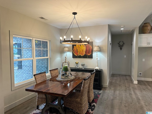 dining space with an inviting chandelier and hardwood / wood-style floors