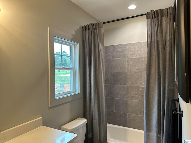 full bathroom with shower / bathtub combination with curtain, vanity, and toilet